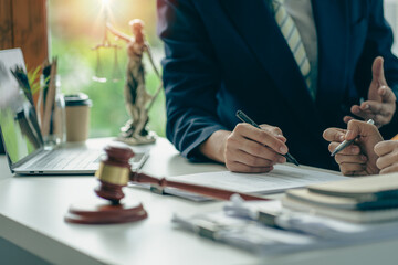 Lawyer working in office with hammer and scales, legal advisor concept