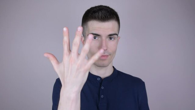Counting to 5 - Handsome Young Man in Navy Blue T-Shirt Demonstrating Finger Counting