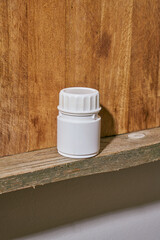 a white plastic painkiller bottle on a shelf