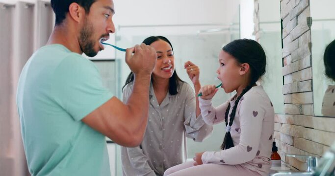 Family, happy and brushing teeth in morning for teaching a child in bathroom for routine. Parents, kid, learn and toothbrush for oral care or fresh breathe for healthy habit in home for dental clean.