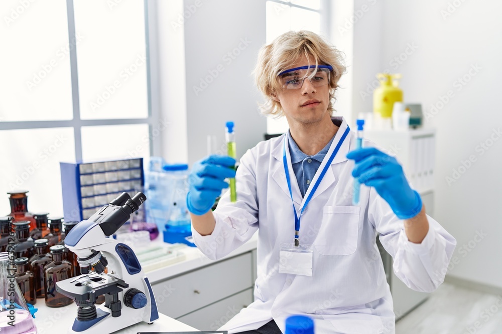 Canvas Prints Young blond man scientist holding test tubes at laboratory