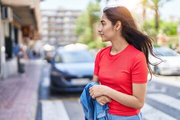Young hispanic girl smiling confident standing at street