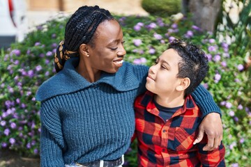 Obraz premium African american mother and son smiling confident hugging each other at park