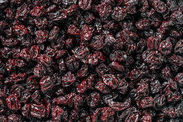 Dry red pitted cherries in the background, closeup, top view. A way to preserve vitamins....