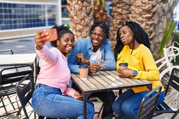 African american friends having breakfast make selfie by the smartphone at coffee shop terrace