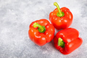 PAPRIKA.Fresh whole red bell pepper on a light textured background. Bulgarian salad pepper .Fresh vegetables. Harvest. Vegan. close up