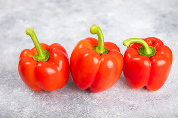 PAPRIKA.Fresh whole red bell pepper on a light textured background. Bulgarian salad pepper .Fresh vegetables. Harvest. Vegan. close up