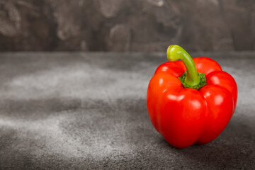 PAPRIKA.Fresh whole red bell pepper on black textural background. Bulgarian salad pepper .Fresh vegetables. Harvest. Vegan. close up