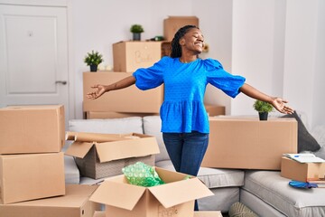 African american woman smiling confident standing at new home