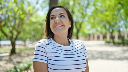 Middle eastern woman smiling confident looking up at park