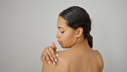 African american woman applying lotion skin treatment on back over isolated white background