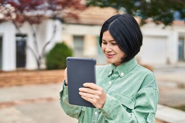 Young chinese woman smiling confident drawing on touchpad at park