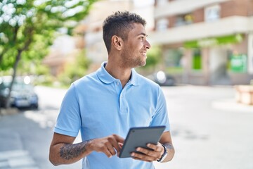 African american man smiling confident using touchpad at street