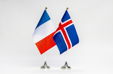 National flags of France and Iceland on a light background.