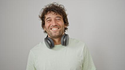 Young hispanic man smiling confident wearing headphones over isolated white background