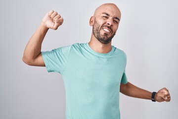 Middle age bald man standing over white background stretching back, tired and relaxed, sleepy and yawning for early morning