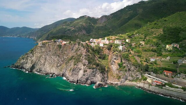 small towns of italy on the coast, sunny weather, filmed with a drone, warm light, blue sea