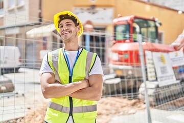 Young hispanic man architect smiling confident standing with arms crossed gesture at park
