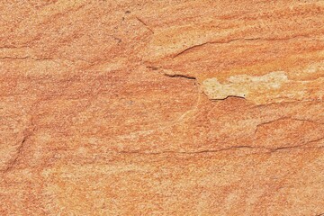 Natural rock texture. Stone grunge background. Light brown rough backdrop. Red ginger pattern. Fragment of mountain close-up. Rusty surface formation of wall with cracks and layer. Copy space for text