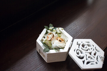 Decorative wedding box with gold wedding rings, decorated with flowers and grass. Image about wedding decor for your design or creative illustrations.