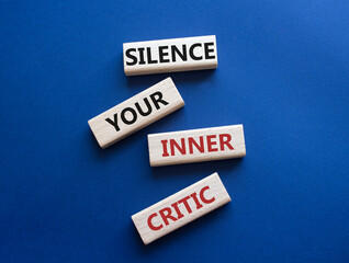 Silence your inner critic symbol. Wooden blocks with words Silence your inner critic. Beautiful...