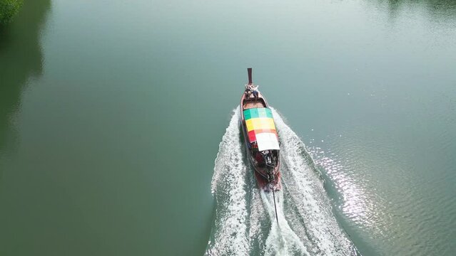 Aerial view tourists girls sunbathing lie sunbathing in longtail boat float water. Boat trip traditional rasta asian river water transport vessel. Travel friends women tourism vacation recreation 4k
