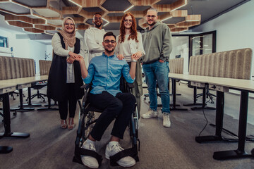 Young businessmen in a modern office extend a handshake to their business colleague in a wheelchair, showcasing inclusivity, support, and unity in the corporate environment.