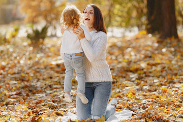 Cute and stylish family in a autumn park