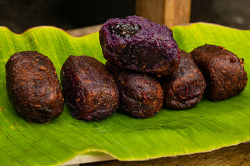 timus is a sweet-tasting food made from mashed sweet potatoes and filled with various sweet fillings. timus on a banana leaf