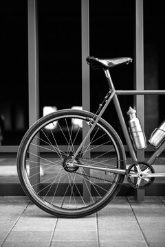 Black and white Photo of a bicycle near the wall