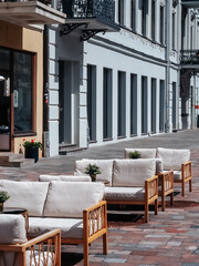 Kaunas, Lithuania - 07 26 2023: Cafe outdoor terrace with soft sofas in the center of the pedestrian street