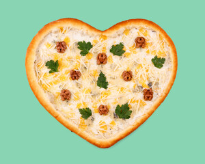 appetizing pizza in the shape of a heart with 4 cheeses (mozzarella, dor blue, parmesan and gouda) on a green background, studio shot 1