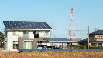 Kasukabe, Saitama, Japan. January 2, 2021. An eco-friendly house with solar panels on its roof and garage roof, as well as in a field out front of the house.   © Shaun