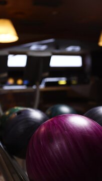 A girl is playing bowling. Close-up 
