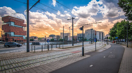 Street and tram track near modern small island in city center of Antwerp, Belgium.