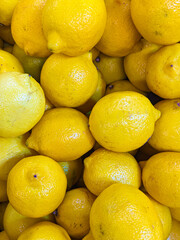 Lots of lemons close-up view from above, vitamin C in citrus fruits.