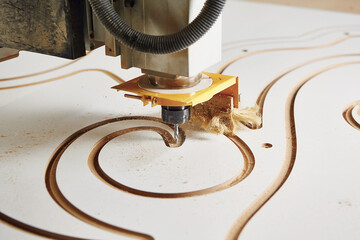 Cnc machine at carpentry workshop. Cutting wood with various router bits.