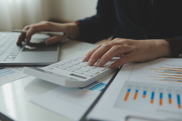 Unrecognizable businessman using calculator