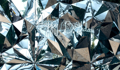 Fototapeta premium The inscription Happy Birthday is made of LED strip against the mirror wall . Decoration for the party.
