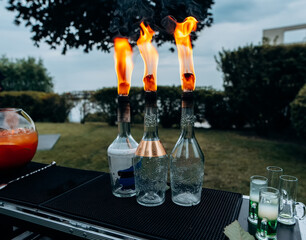 Barman show. burning bottles of alcohol for alcoholic cocktails. Fire show