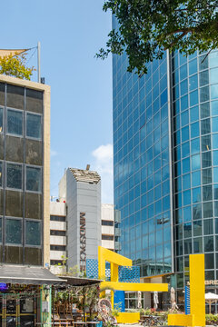 View of modern skyscrapers in the city center of Tel Aviv at the crossroads between Sderot Rothschild and Yavne Street with street scenes, max Brenner restaurant and mindspace co working area.
