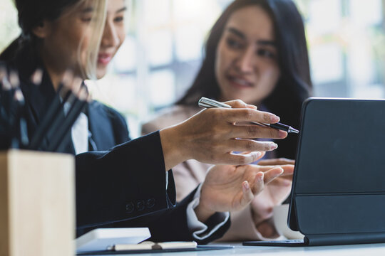 Colleagues working together in the office. Businesswoman discussing with colleagues at work about work and presenting ideas for starting a new business project. - Powered by Adobe