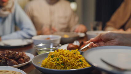 Close-up dish of halal food biryani rice on plate. Asia muslim sweet daughter serve food to mother...