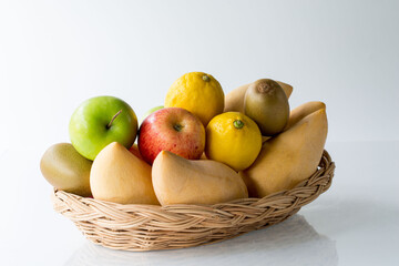 Assorted fresh mix fruits in a rectangle basket on white background, concept fruit in shop and supermarket..