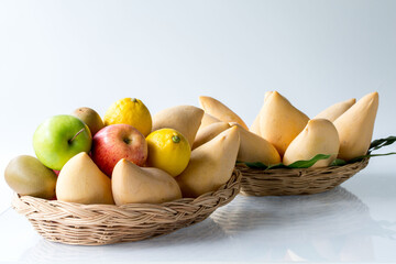 Assorted fresh mix fruits in a rectangle basket on white background, concept fruit in shop and supermarket..