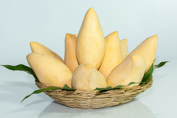 Organic Nam Dok Mai thai Mangoes and leaves in basket, Sweet, tasty, refreshing.It is the most popular mangoes variety in Thailand. concept vitamin from fruit and  information in supermarket..