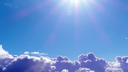 Dazzeling sunbeams above the clouds