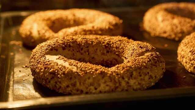 Timelapse of bagels with sesame baking in oven. Turkish simit rising up in oven. Turkish traditional food. Baking concept. Homemade bakery. Fresh buns. Close-up in 4K, UHD