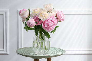 Beautiful peonies in glass vase on table © New Africa