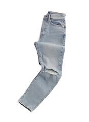 Rumpled light blue jeans isolated on white, top view. Stylish clothes